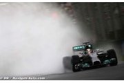 Hamilton takes pole in rain soaked Sepang