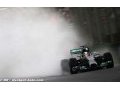 Hamilton takes pole in rain soaked Sepang