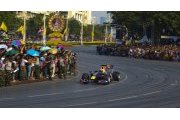 Red Bull's Mark Webber drives past Thai fans