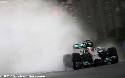 Hamilton takes pole in rain soaked Sepang